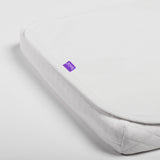White mattress cover with a purple label on a light gray background