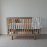 George Cot with mattress and toy on a white background